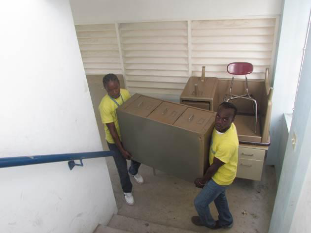 Food For The Poor staff bring new furnishings into St. Georges College